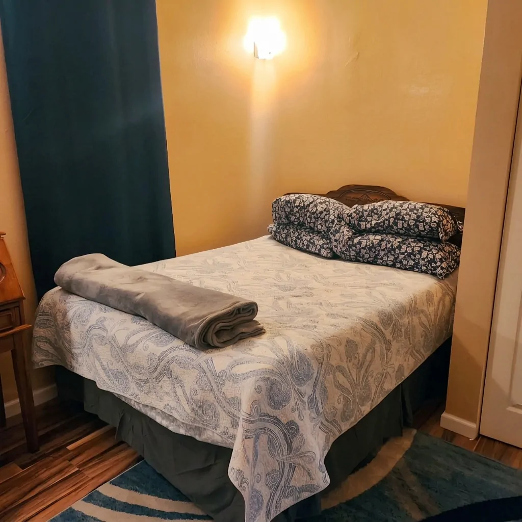 Extended-stay bedroom with patterned quilt