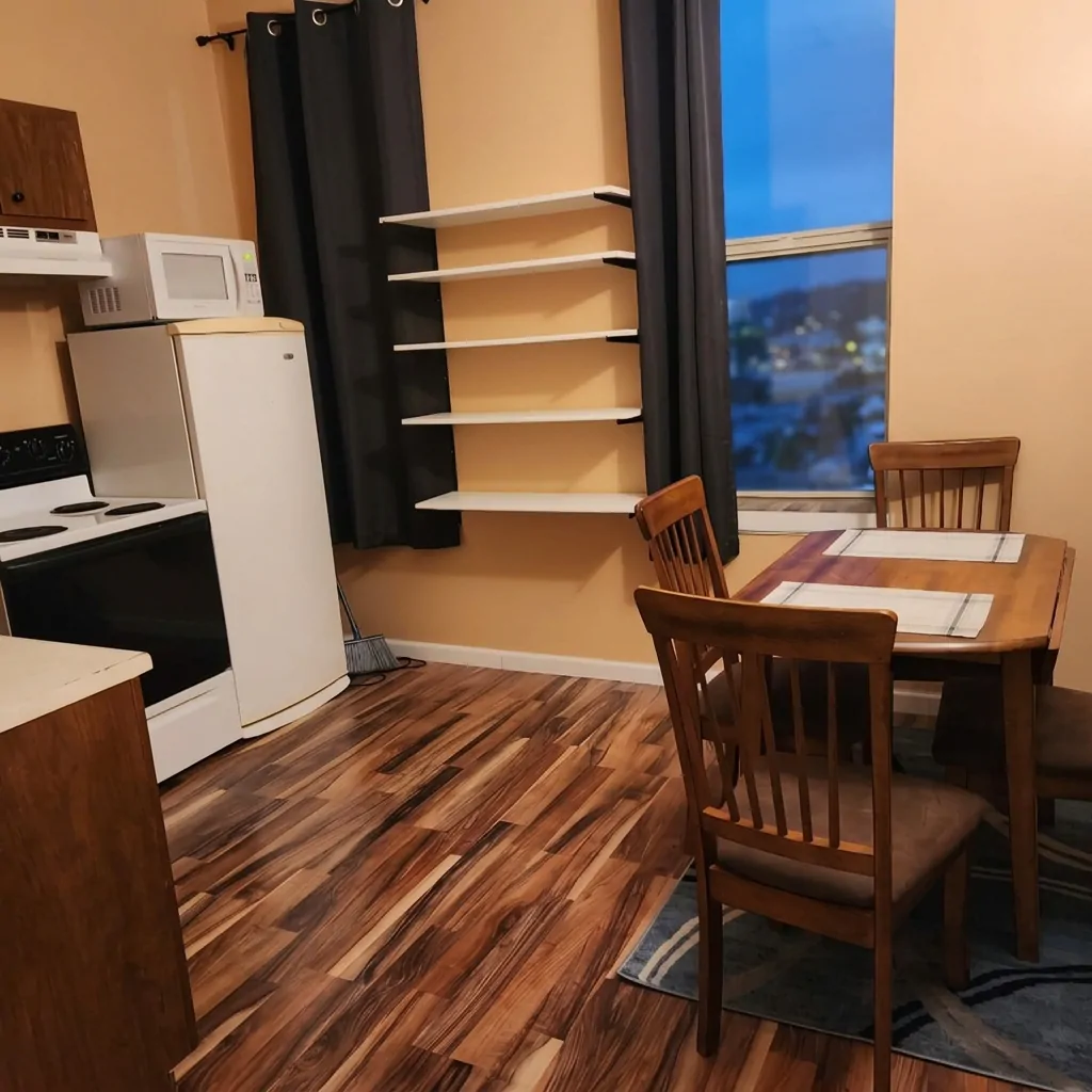 Extended-stay kitchen with stove, fridge and a dining table for two