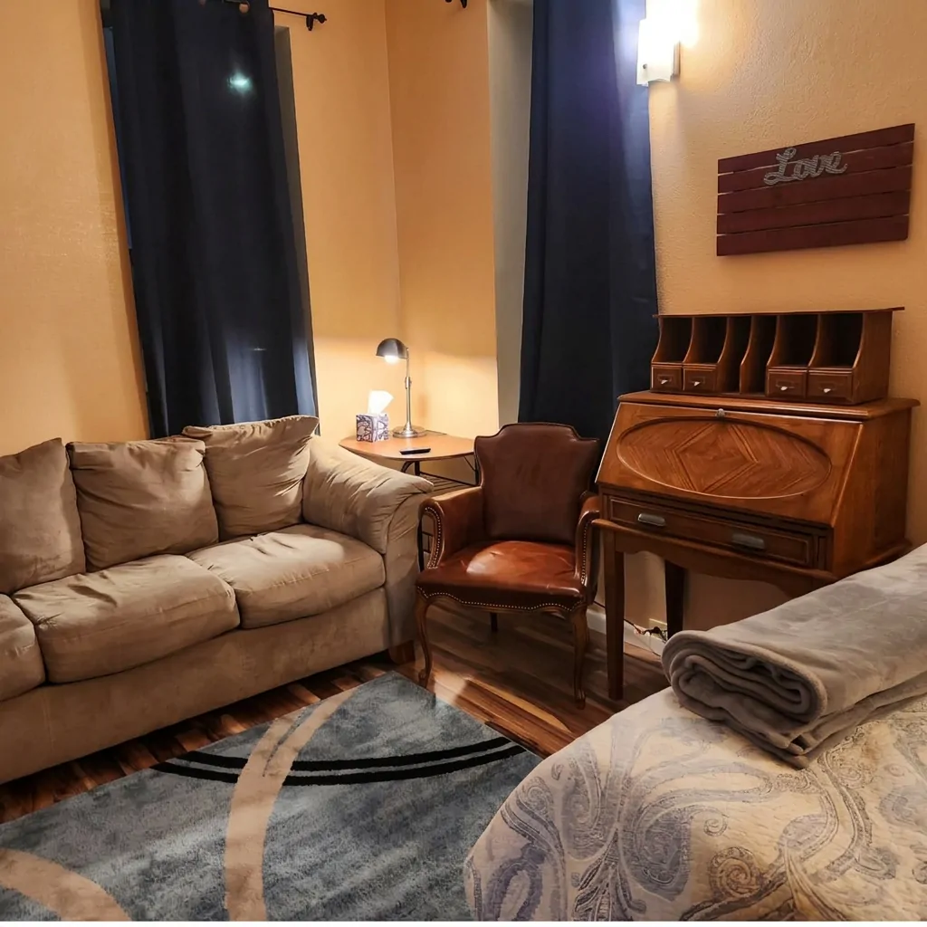 Extended-stay sitting area with sofa, leather chair and desk